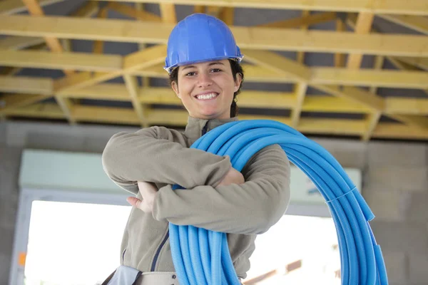 Female Construction Worker Holding Reel Blue Conduit — Stock Photo, Image