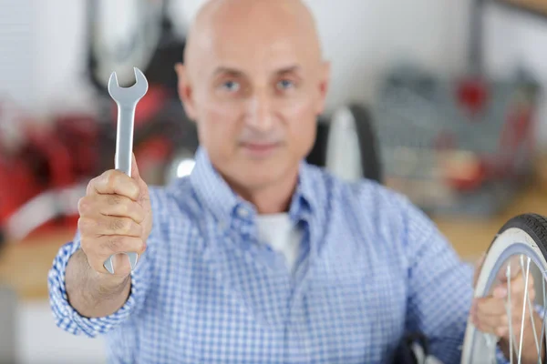 man holding a wrench