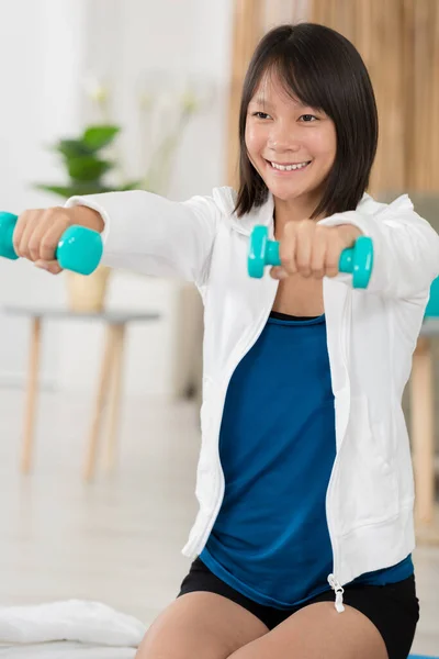Happy Girl Exercising Dumbbells Indoors — Stock Photo, Image