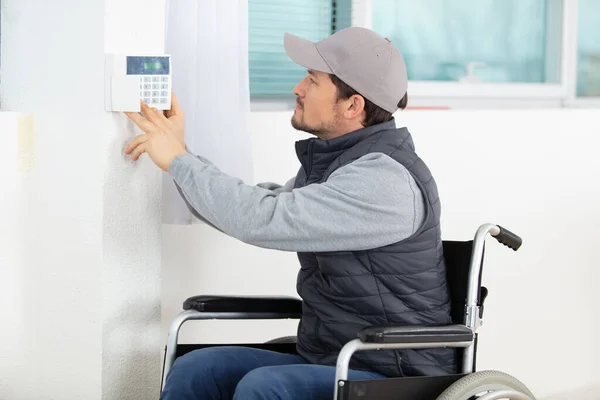 男电工在墙上安装安全系统门传感器 — 图库照片