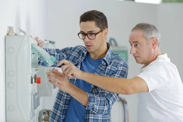 Two Professional Electricians Checking Industrial Control Box — Stok fotoğraf