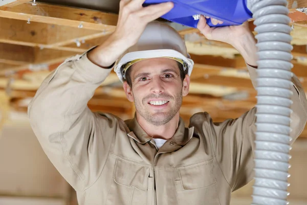 Tradesman Fitting Ventilation System Overhead Rafters — Stock Photo, Image