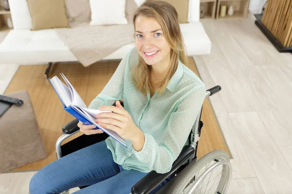 Contented Woman Wheelchair Reading Book —  Fotos de Stock