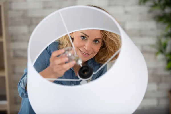 Attractive Blond Woman Energy Saving Light Bulb — стоковое фото
