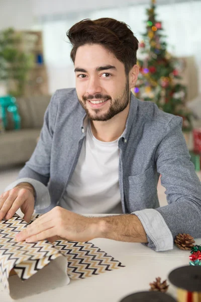Smiling Man Wrapping Christmas Presents — Photo