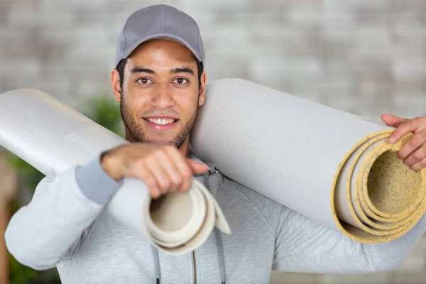 Young Handyman Carrying Rolls Wallpaper — Stock Photo, Image