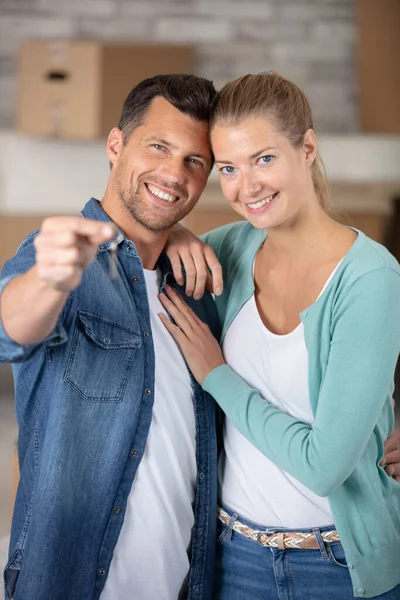Happy Couple Embracing While Man Showing Key New Flat — Stockfoto