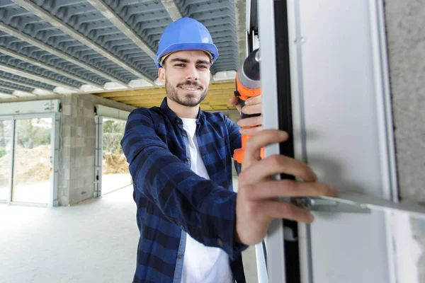 Young Male Builder Using Power Tool — Foto de Stock