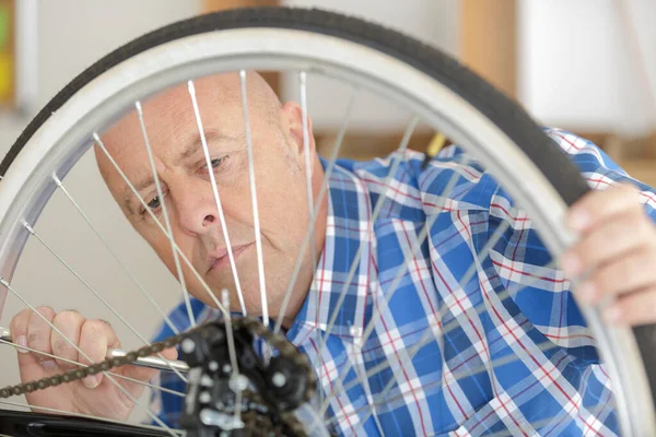 Mature Man Pumping Wheel Bike — Stock Photo, Image