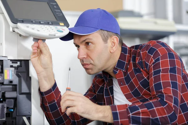 Concentrated Man Repairing Printer — Stok fotoğraf