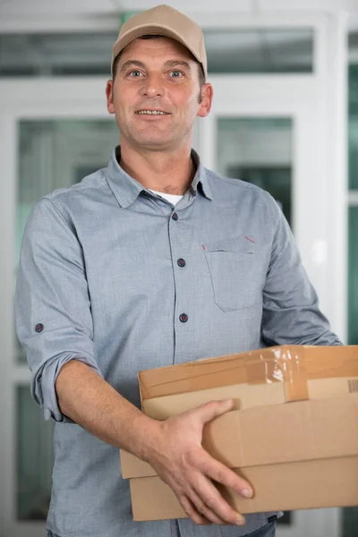 Smiling Young Delivery Man Holding Carrying Cardbox — Stock Photo, Image
