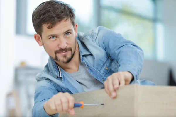 Happy Man Fixing Furniture — Stock Photo, Image