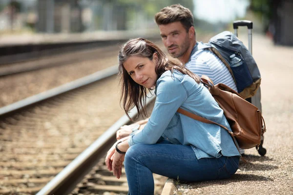 Couple Sitting Train Station Smileless Facial Expression — Stok fotoğraf