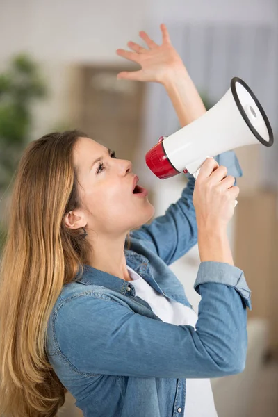young woman shouting through a megaphone