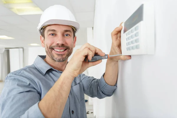 Happy Male Plumber Fixing Thermostat Home — Stockfoto