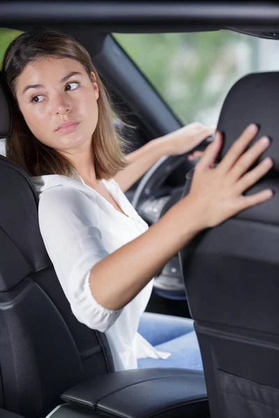 woman driving a car in reverse