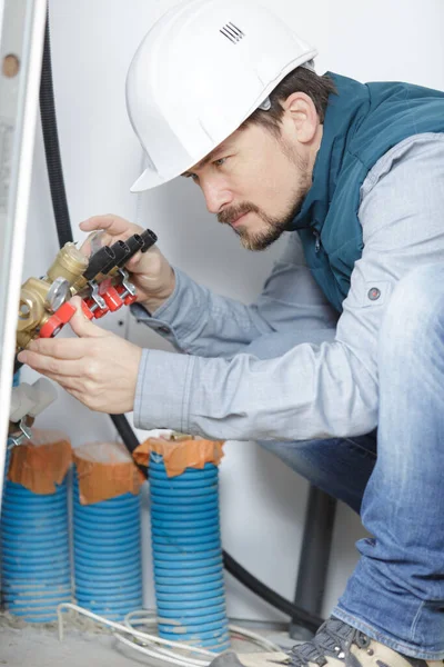 Technician Inspecting Heating System Wearing Helmet — Stock fotografie