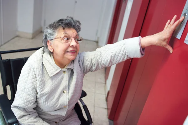Elderly Woman Wheelchair Reaching Elevator Button — Stock Photo, Image
