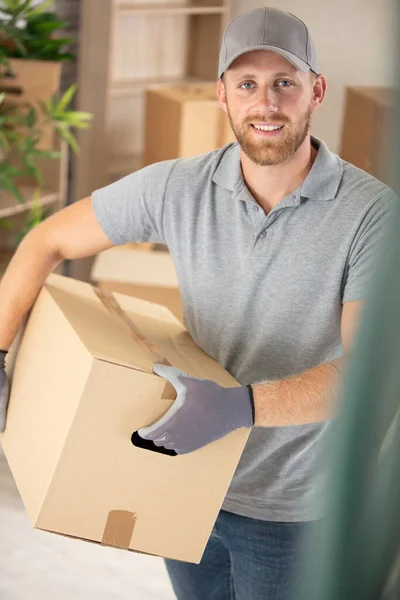Happy Handsome Deliveryman Holding Box — Stock Photo, Image