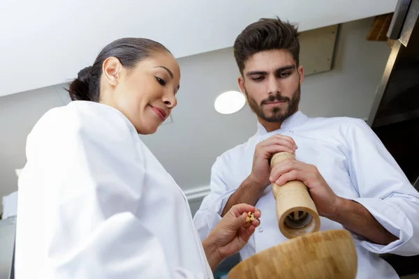 Young Chef Putting Some Fresh Ground Pepper — Stockfoto