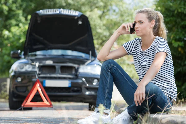 woman broken down telephoning for assistance