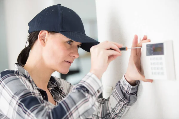 Female Technician Installing Security System Using Screwdriver — Photo