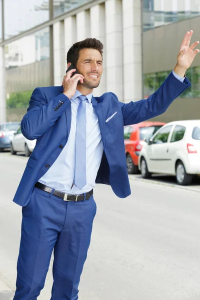 young bearded business man asking taxi on the phone
