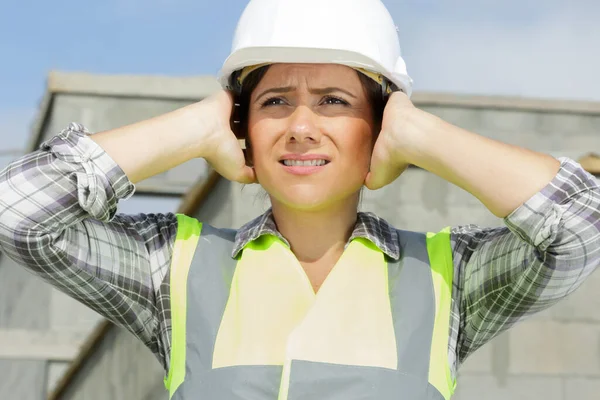 architect woman frustrated and covering ears with hands