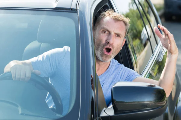 angry man driving a car