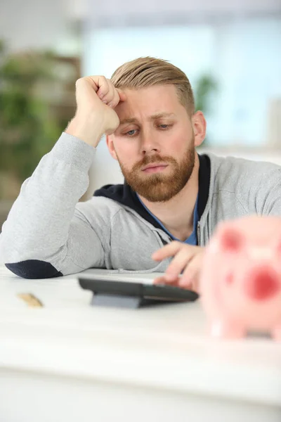 frustrated businessman calculates the cost