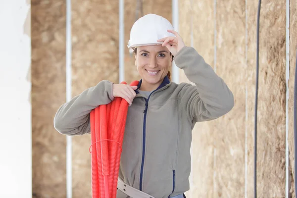 Female Worker Carrying Reel Red Pipe — Stock Photo, Image