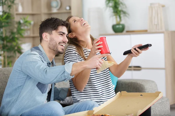 the happy man and a woman watch television