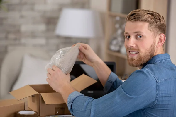 Young Manual Worker Opening Parcel — Stock Photo, Image