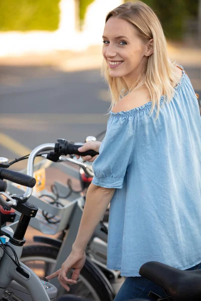 Attractive Girl Unlocking Rental Bicycle — Stock Photo, Image