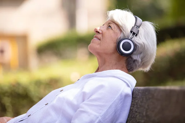 Χαρούμενη Ηλικιωμένη Γυναίκα Που Ακούει Μουσική Ακουστικά Και Smartphone — Φωτογραφία Αρχείου