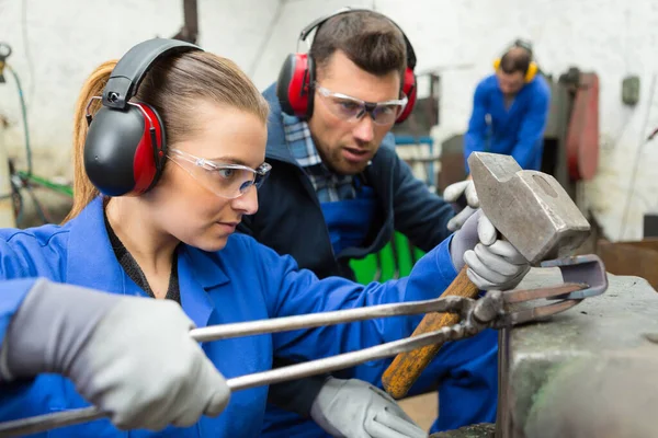 工人用铁锤在铁锤上锻造金属 — 图库照片