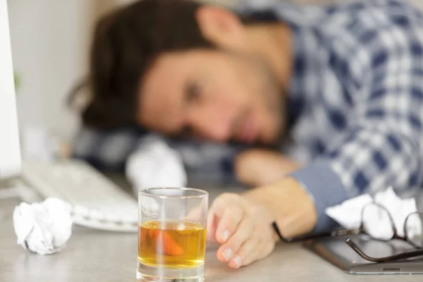 Man Slumped Desk Reaching Alcoholic Drink — Stock Photo, Image