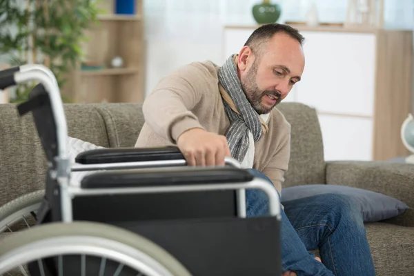 Disabled Man Tries Move Sofa Wheelchair — Stock Photo, Image
