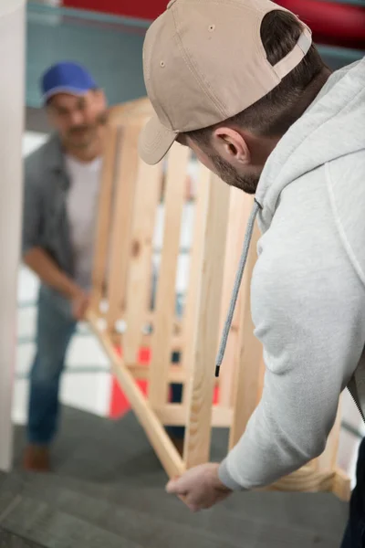 Two Male Movers Carrying Empty Shelf Staircase — Stock Photo, Image