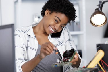 happy young woman fixing a pc clipart