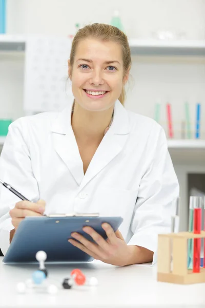 Smiling Young Nurse Writing Clipboard — Stock Photo, Image