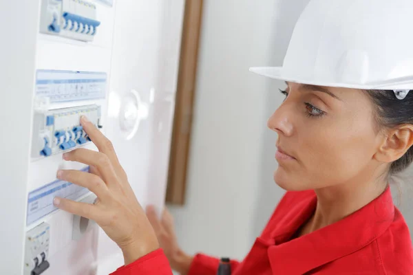 Lady Inspecting Fuse Board — 스톡 사진