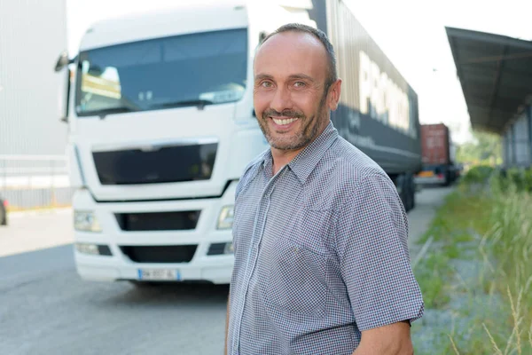 happy driver next to his lorry
