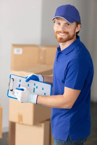 Delivery Man Checking List Clipboard Indoors — Stock Photo, Image