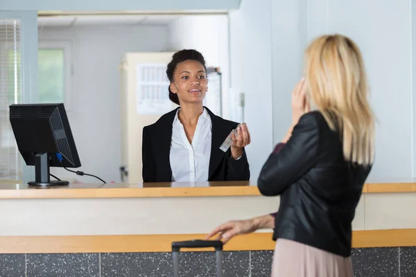 hotel reception worker with female customer