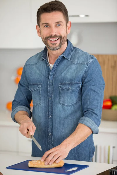 Handsome Man Cutting Bread Smiling — Stock Photo, Image