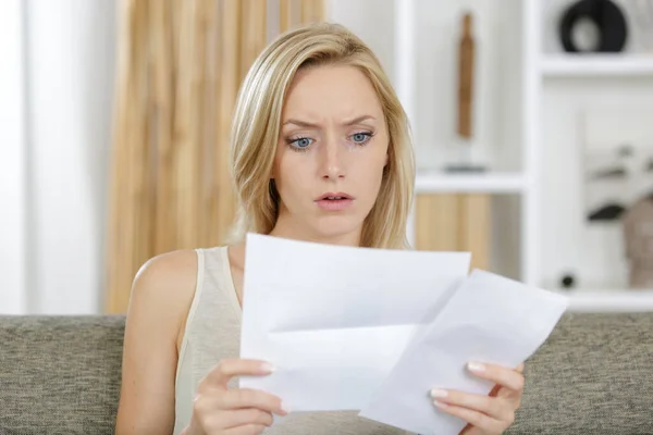 beautiful woman surprised while reading a letter