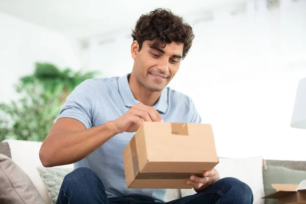 Excited Man Opening Delivery Cardboard Box — Stock Photo, Image