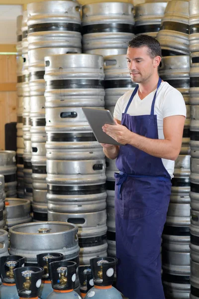 Male Worker Holding Digital Tablet Barrels Beer — Stock Photo, Image