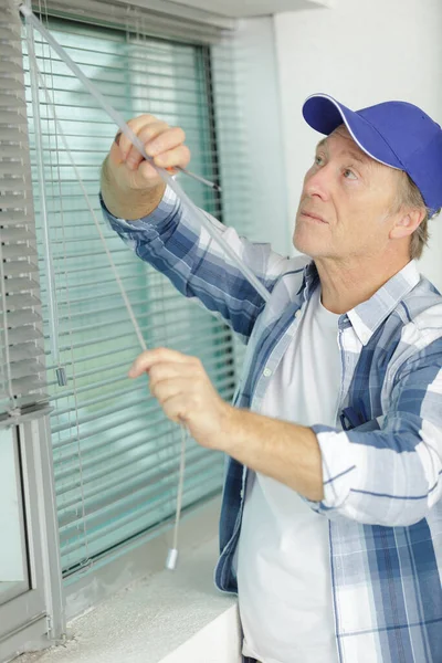 Mature Man Installing Roller Shutter Window — Stock Photo, Image